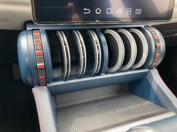 Ein Getränkehalter mit mehreren Fächern in einem Auto.