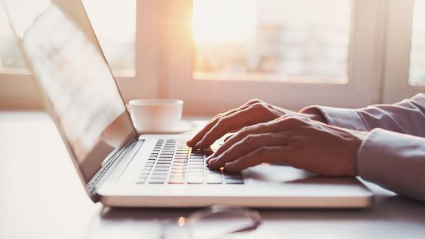 Place of work, man using laptop computer