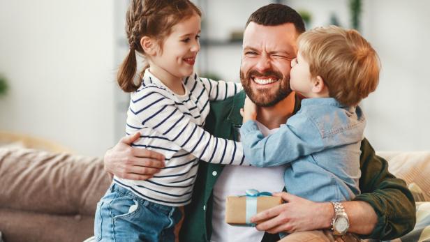 Happy father getting congratulations from kids