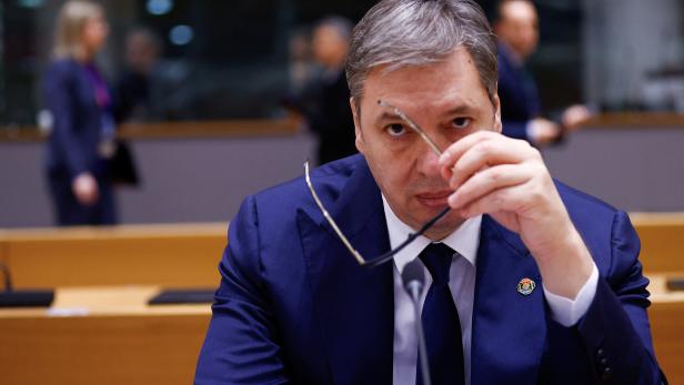 Aleksandar Vučić hält seine Brille in der Hand.