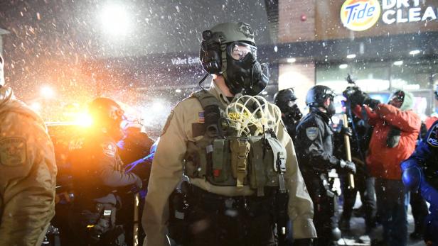 People protest after fatal shooting of man by federal agents