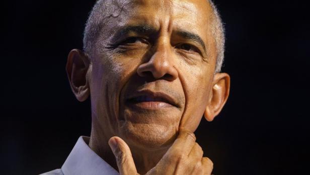 Nahaufnahme von Barack Obama, der nachdenklich sein Kinn berührt.