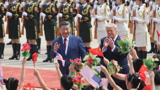 Chinese President Xi Jinping and U.S. President Donald Trump attend a welcome ceremony at the Great Hall of the People, in Beijing