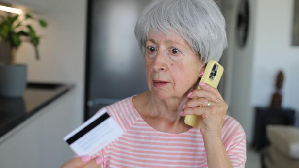 Skeptical looking senior woman during phone call