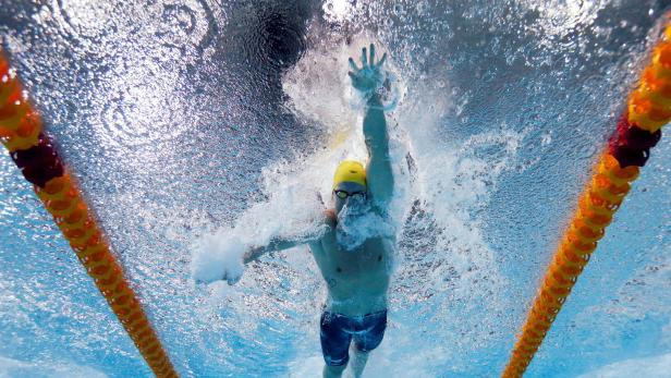 FILE PHOTO: Magnussen of Australia is seen underwater as he swims in the men's 100m Freestyle final during the 2014 Commonwealth Games in Glasgow